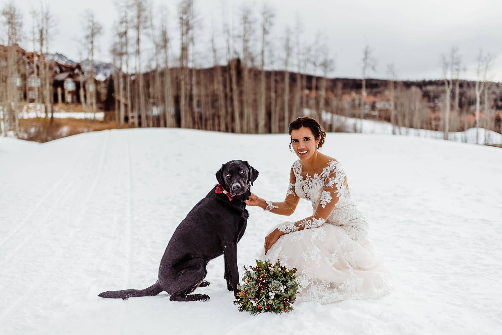 bride with flower dog with cranberry bowtie