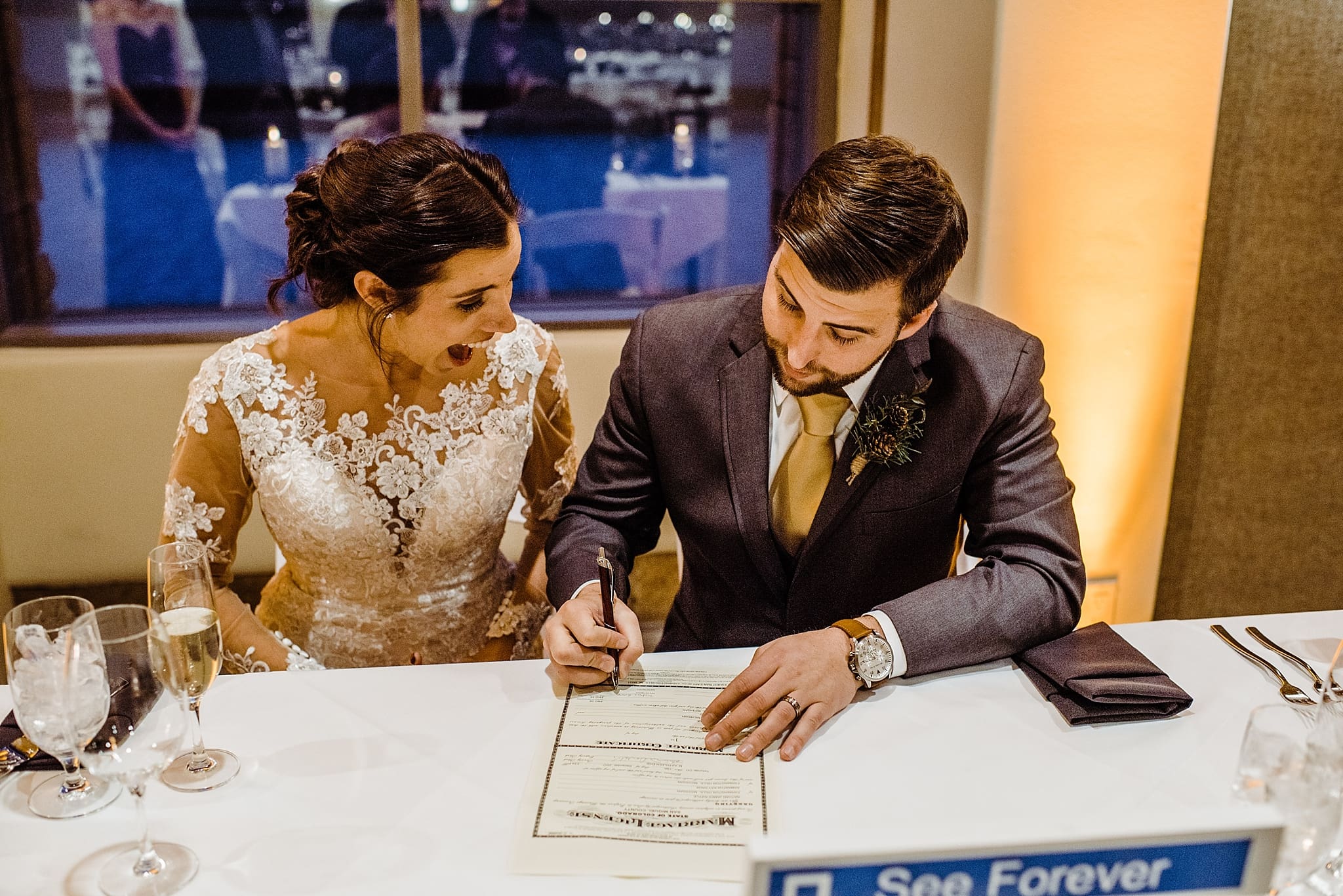 bride and groom signing their marriage certificate