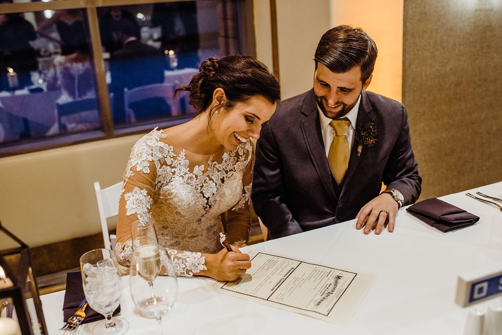 bride and groom signing their marriage certificate
