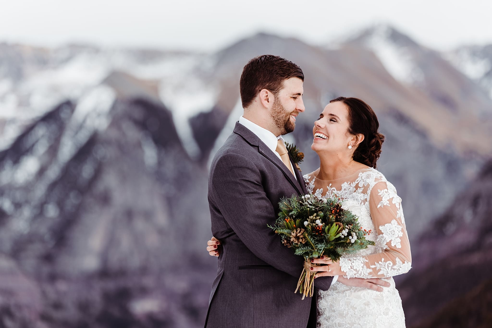 wedding couple laughing in the snow
