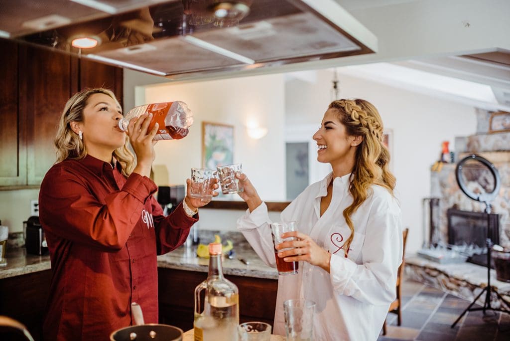 bride taking shots with maid of honor