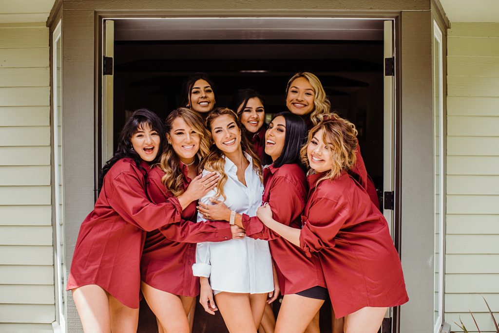 bridesmaids with matching red robes