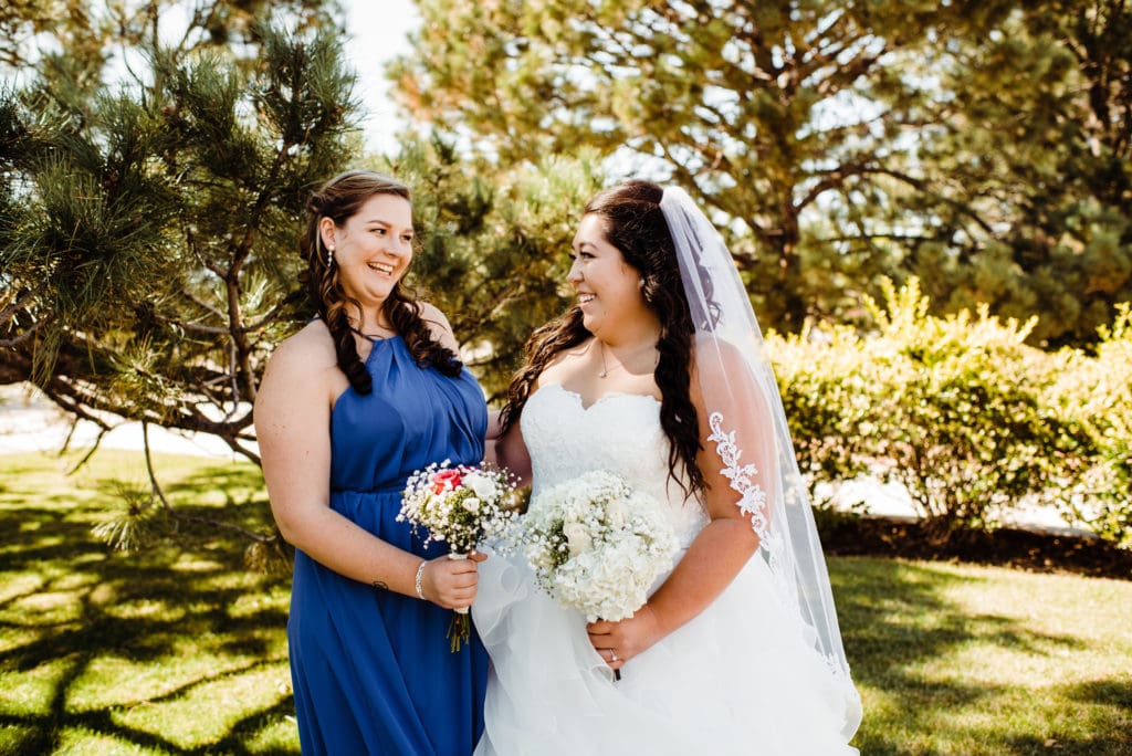 bride and bridesmaid in blue dress