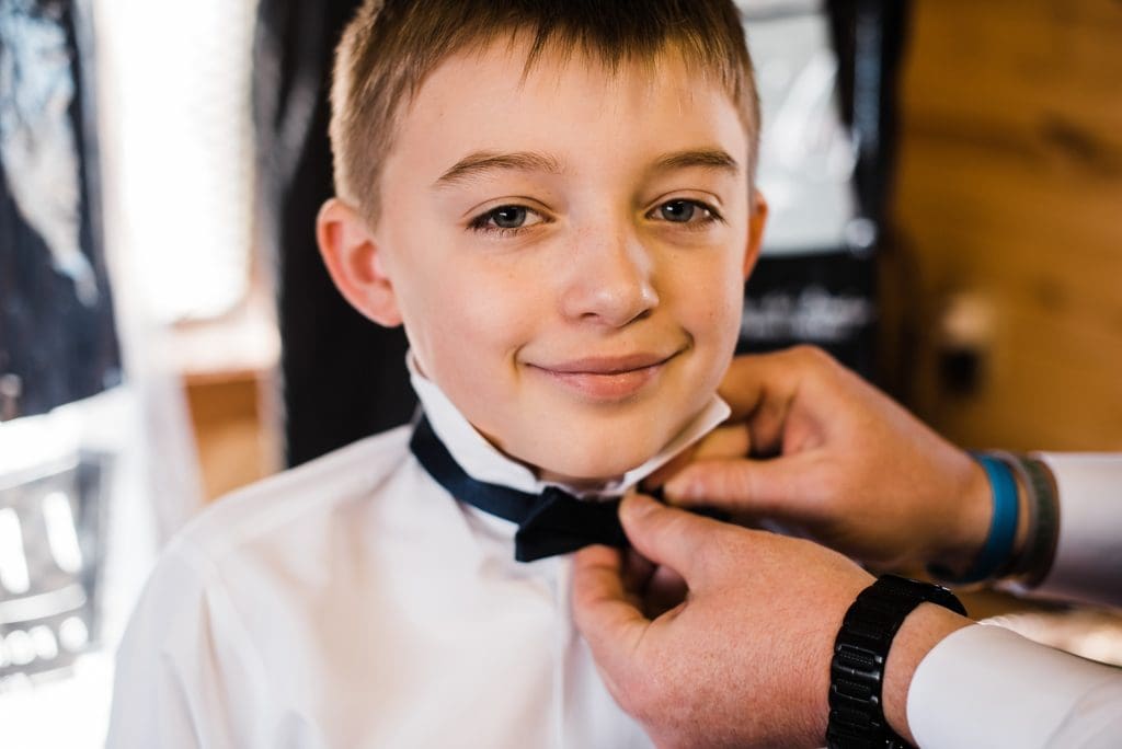 ring bearer getting ready at rustic lace barn