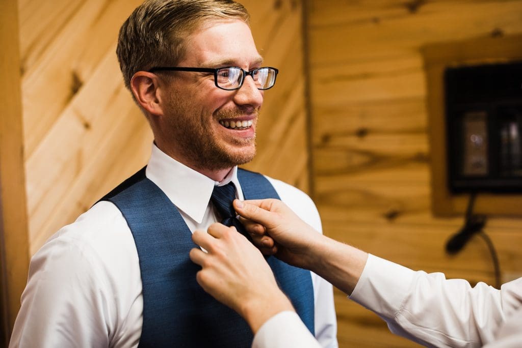 groom getting ready at rustic lace barn