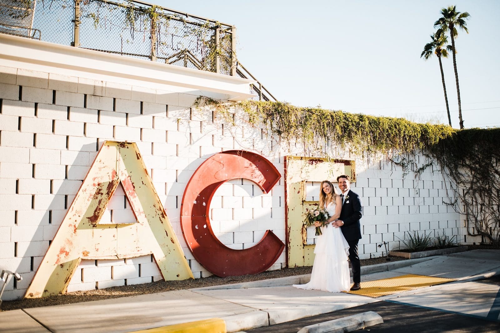 wedding photos at the front of the ace hotel in palm springs