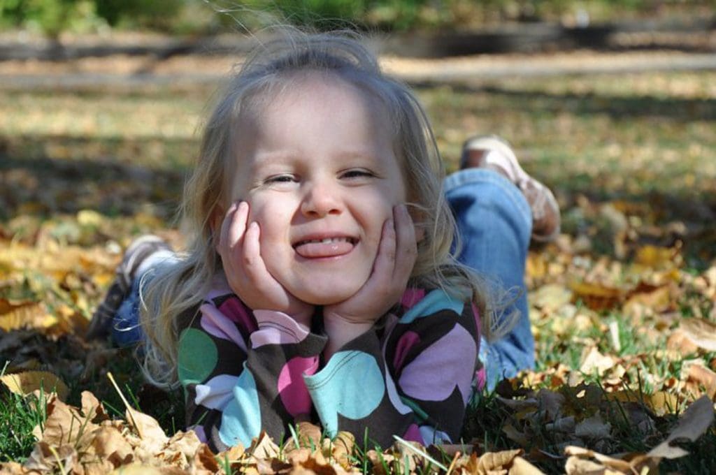 silly girl in the fall leaves