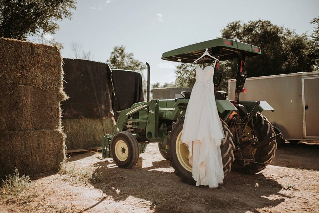 wedding dress on a tractor