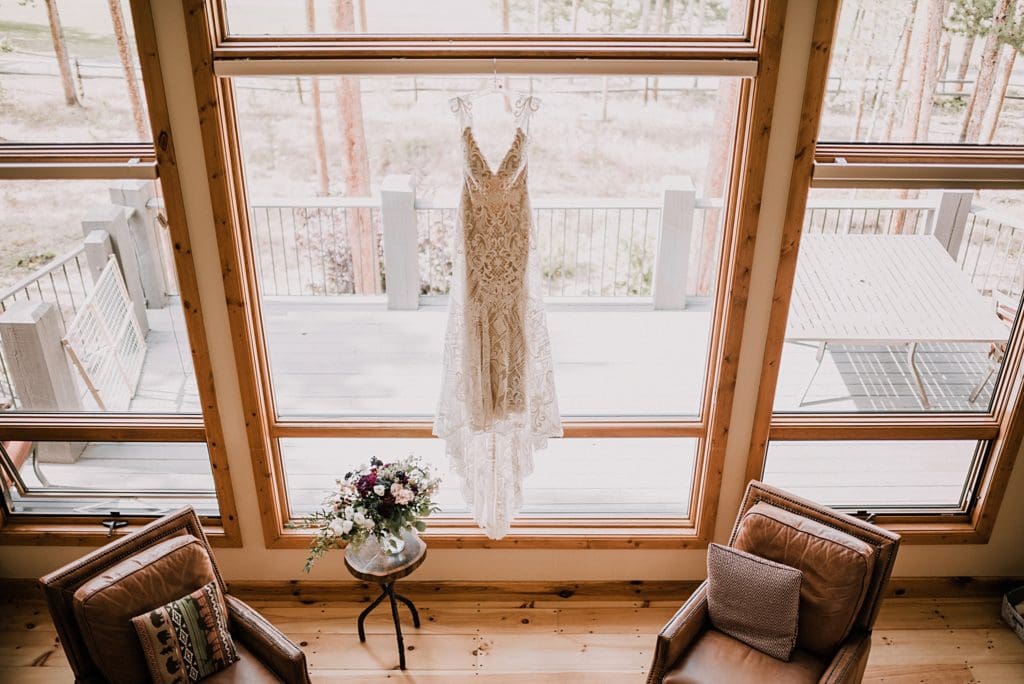 wedding dress hanging up in the window