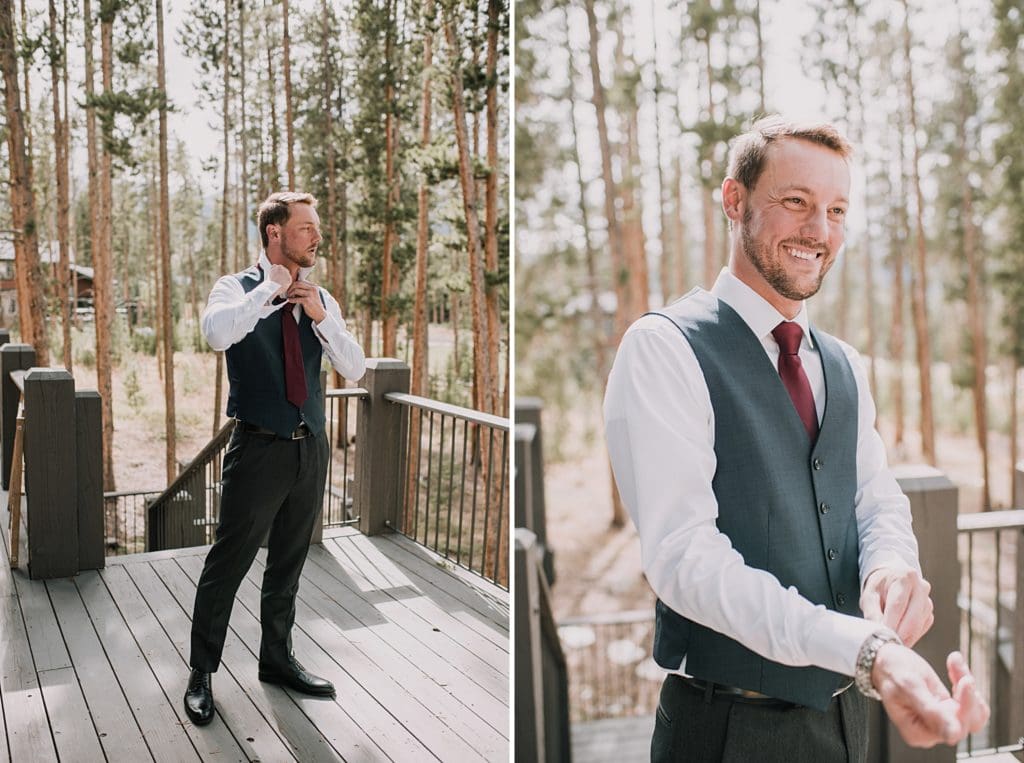 groom getting ready outside cabin for mountain wedding
