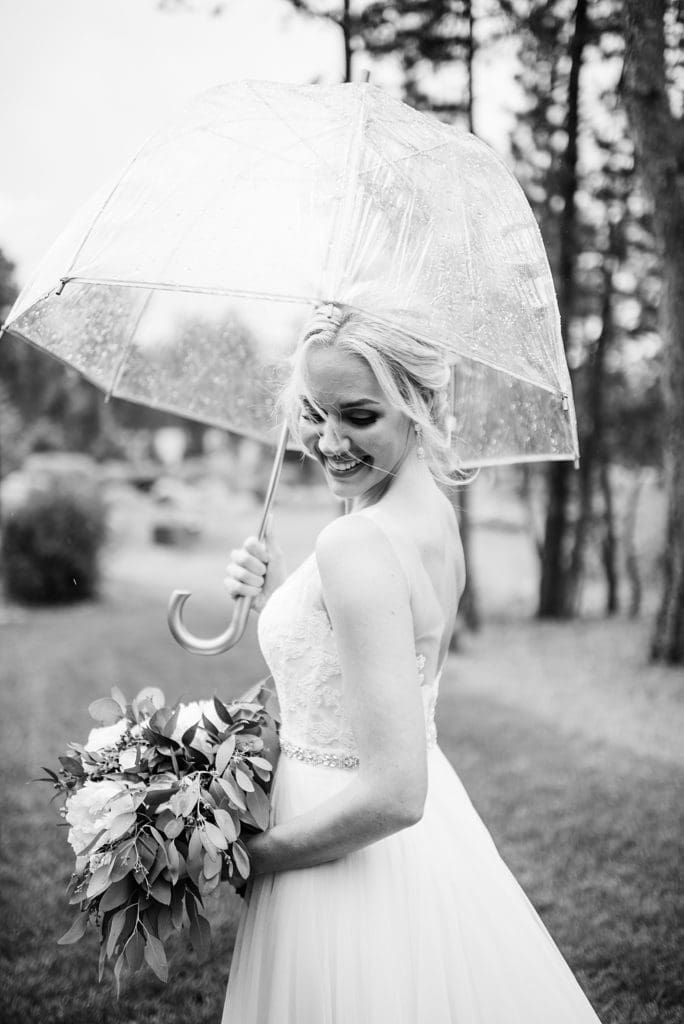 rainy wedding day bridal portrait with umbrellas