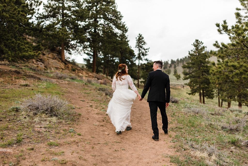 bride and groom hiking for colorado wedding