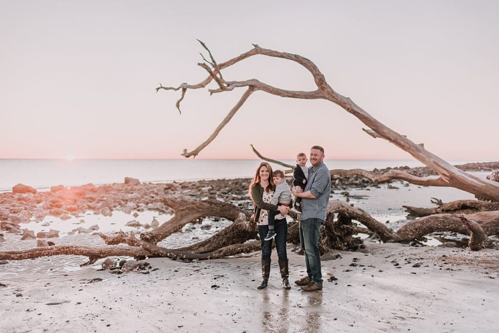 family with the driftwoods on the beach