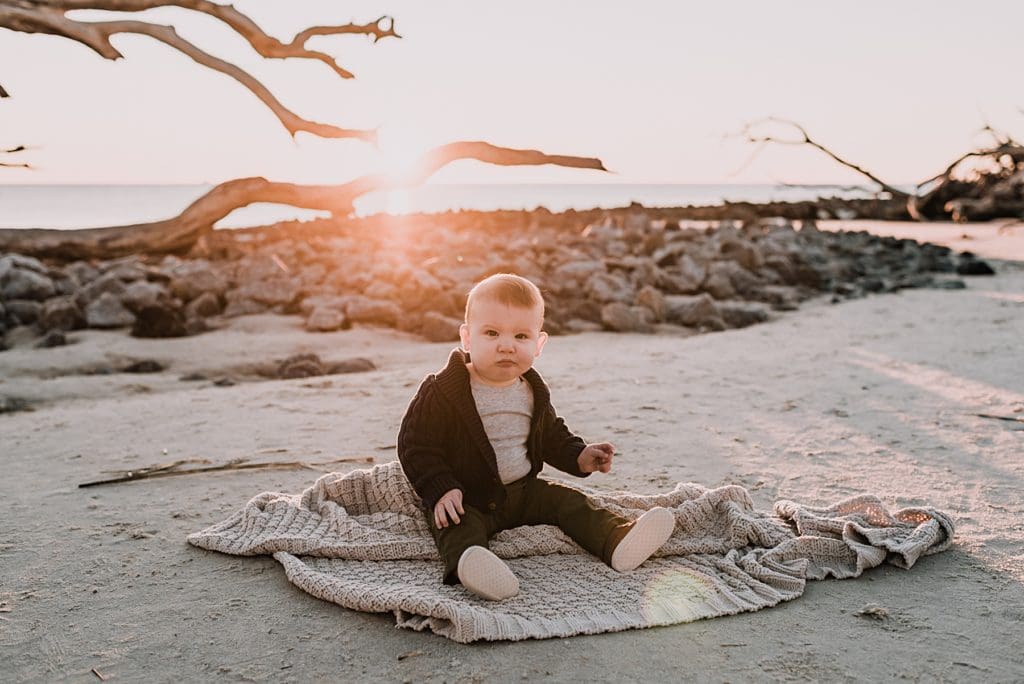 baby on a blanket at sunrise