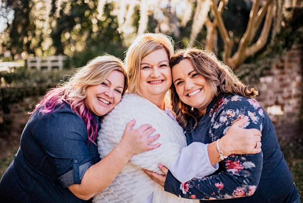 mother and two daughters hugging