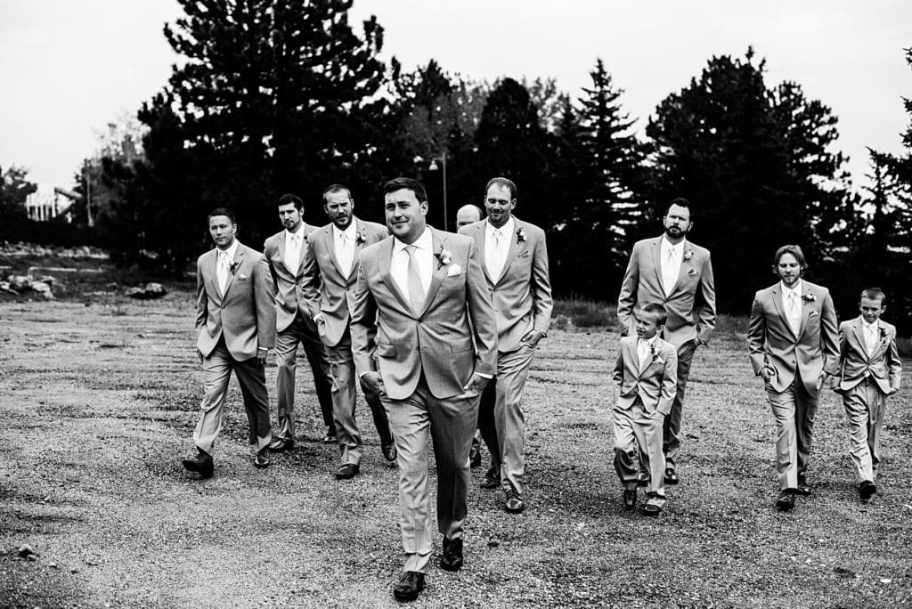 black and white shot of groom party walking together