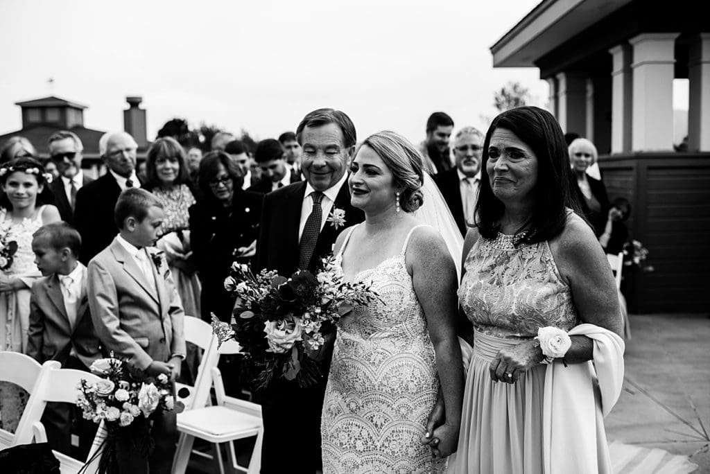 bride walking down the aisle with her parents