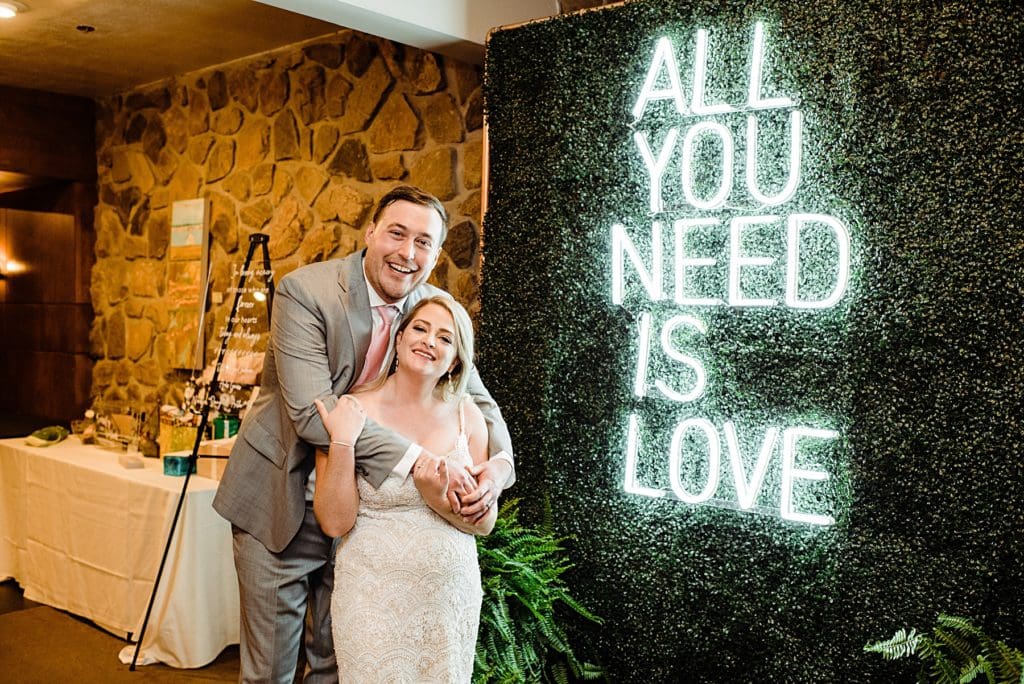 wedding couple with neon wedding sign