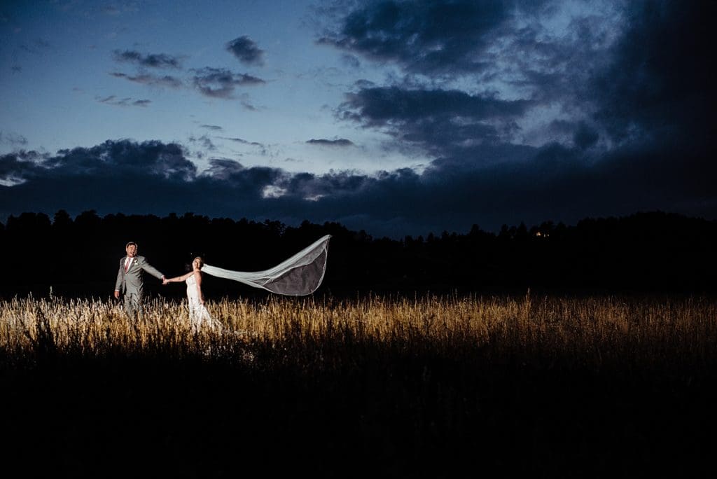 bride and groom with a dramatic veil using off camera flash