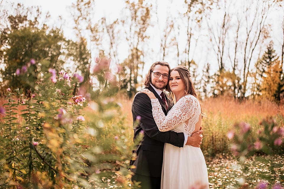 bride and groom in the fall foliage