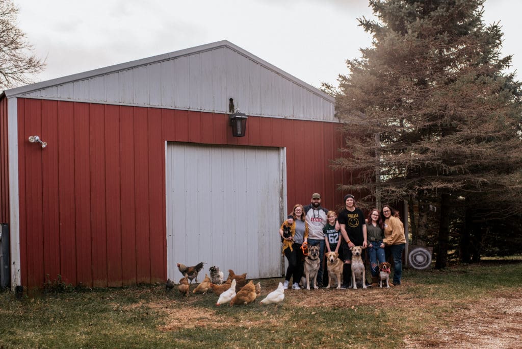 large family with dogs and chickens