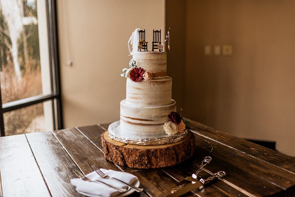naked wedding cake with fishing rod cake topper