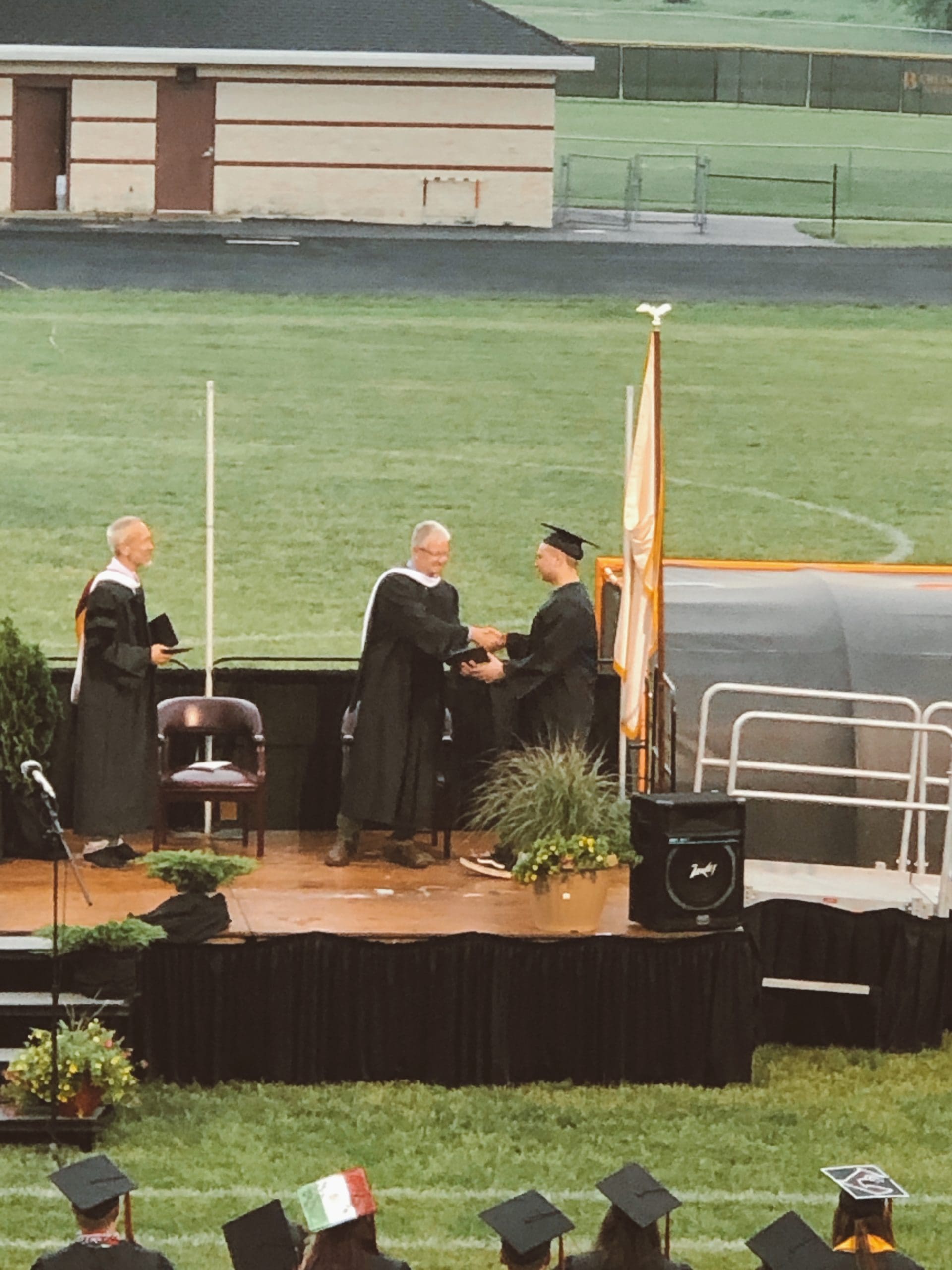 senior receiving diploma at graduation ceremony