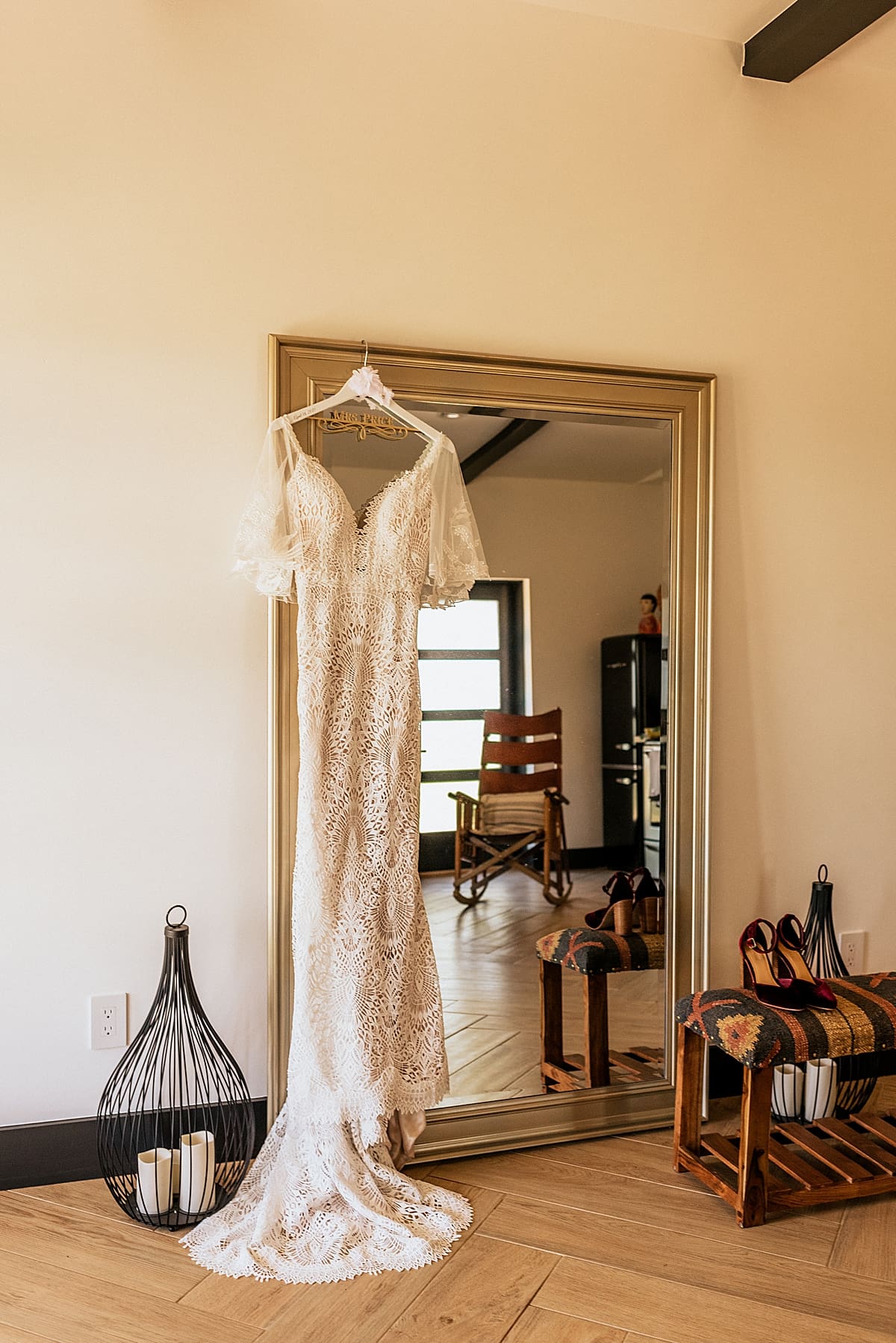 brides dress hanging up on a mirror
