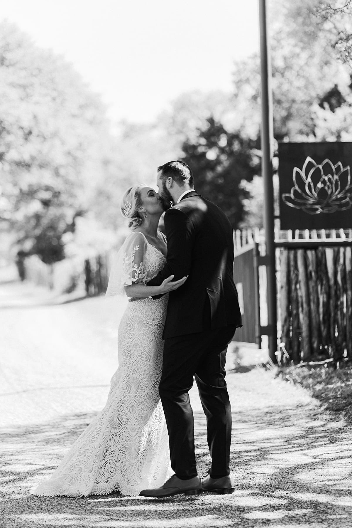black and white image of bride and groom kissing