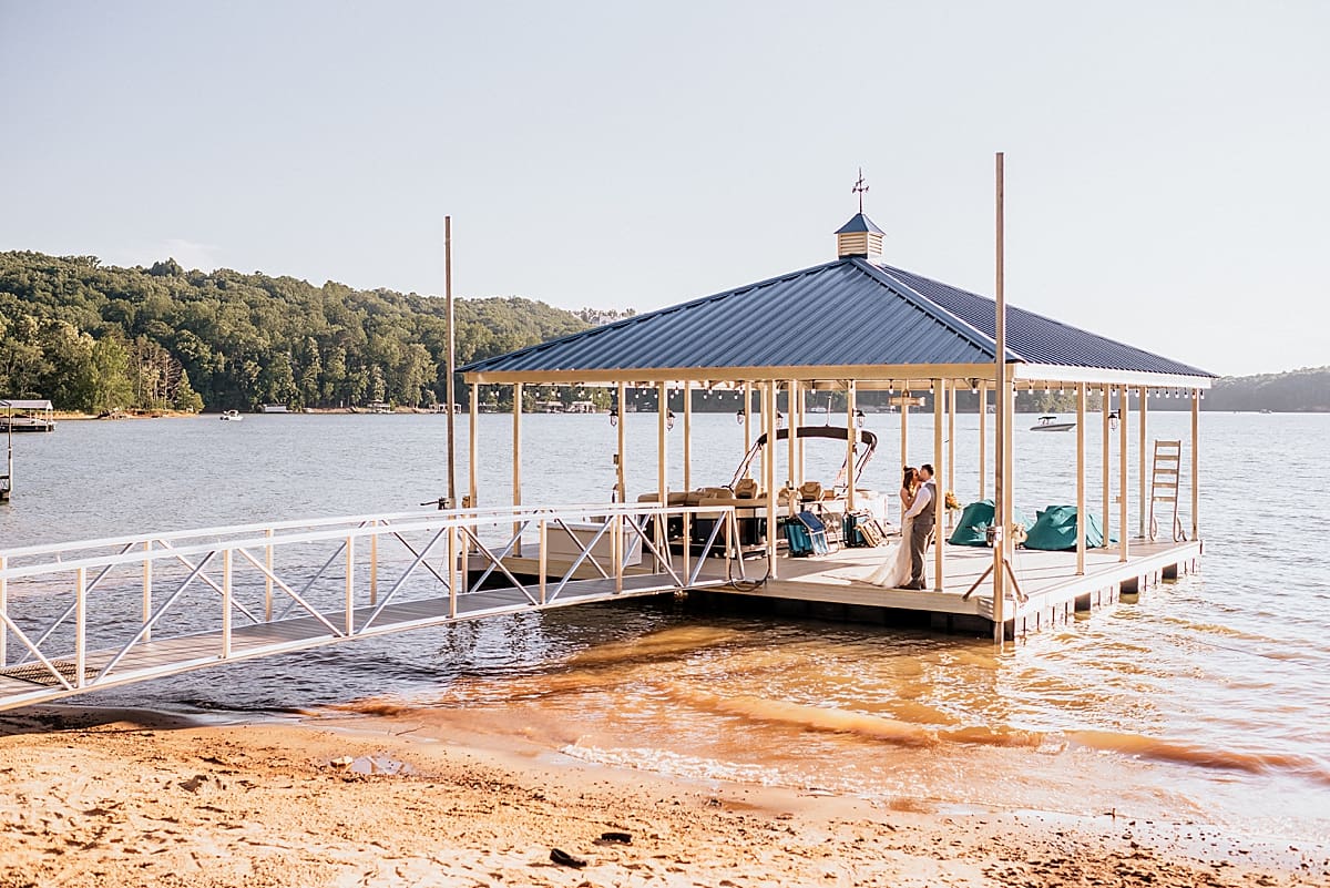 bride and groom on a private lake dock