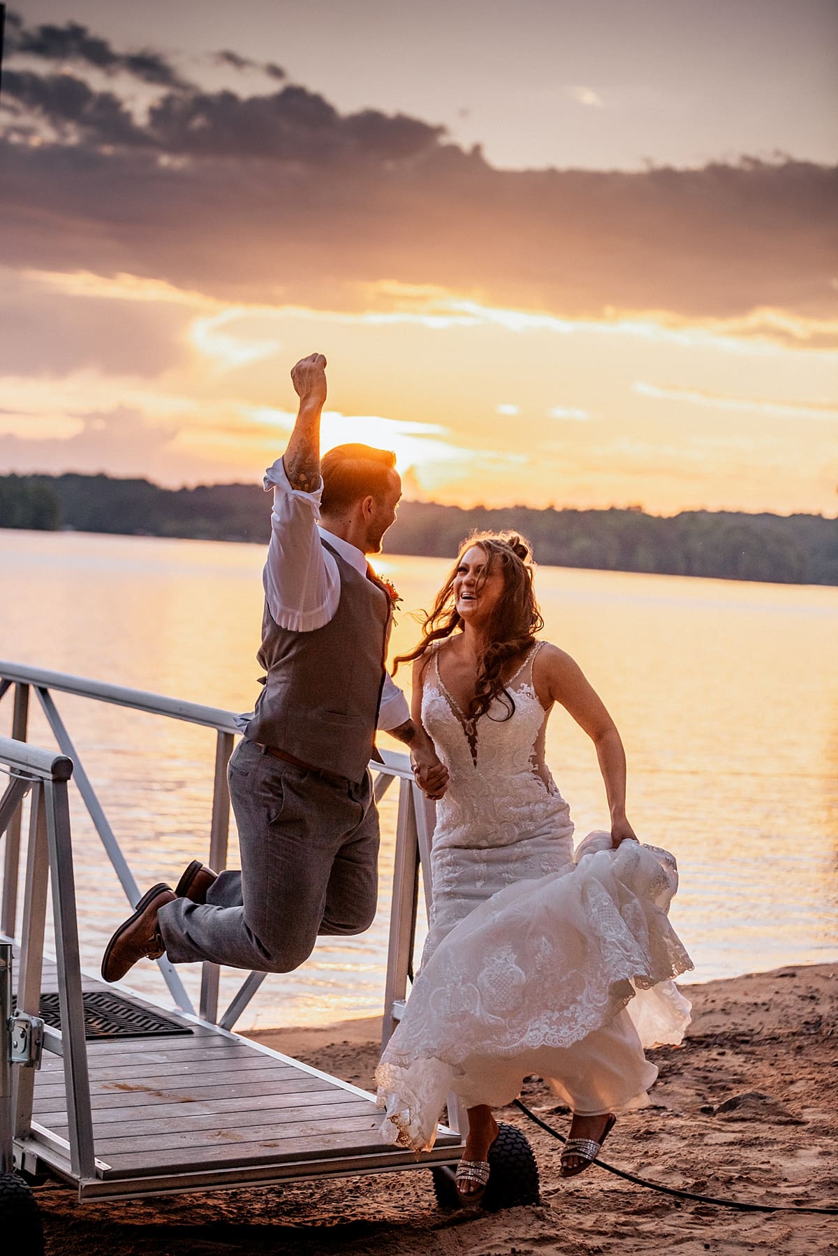 excited bride and groom at sunset
