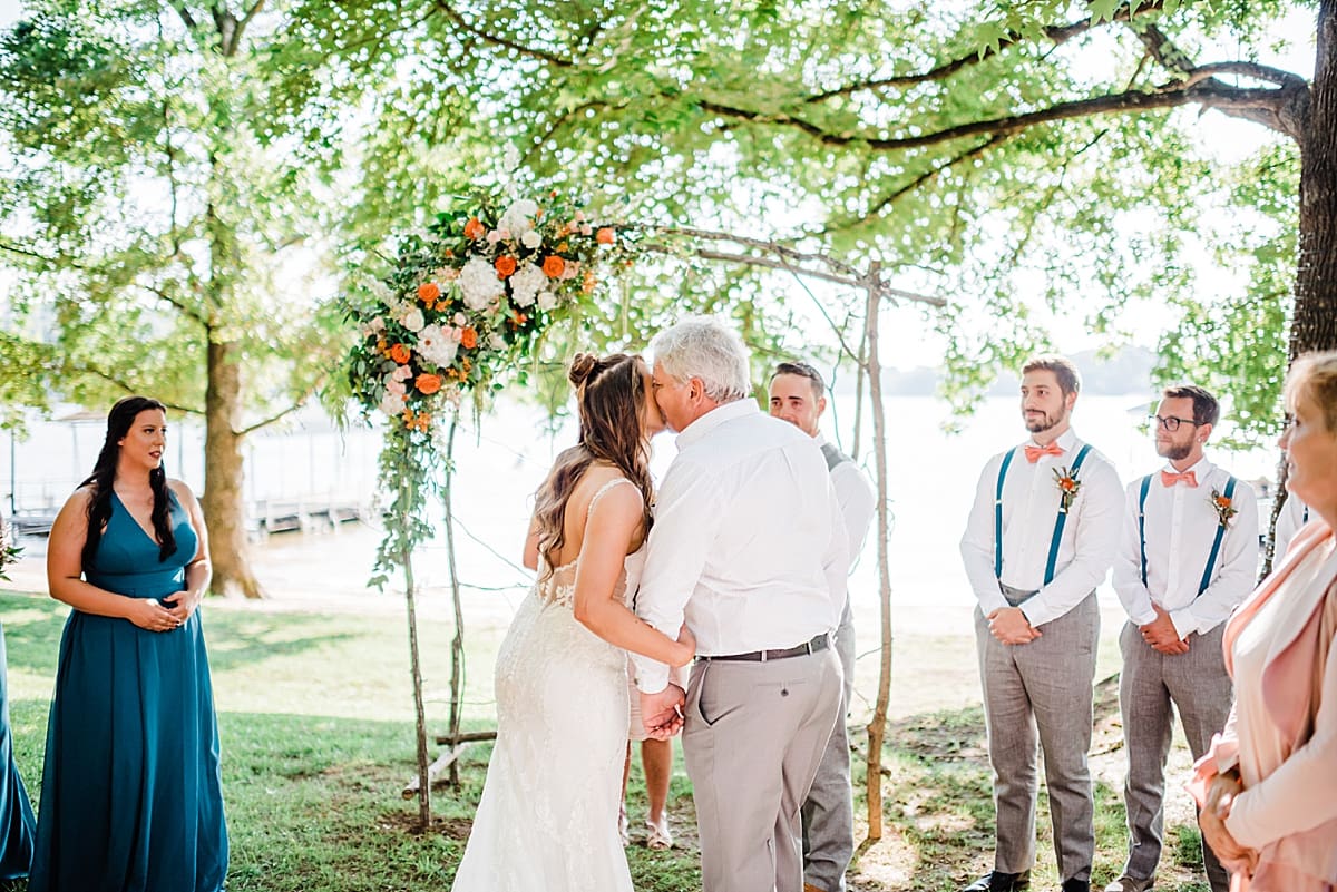 father kissing the bride at the altar