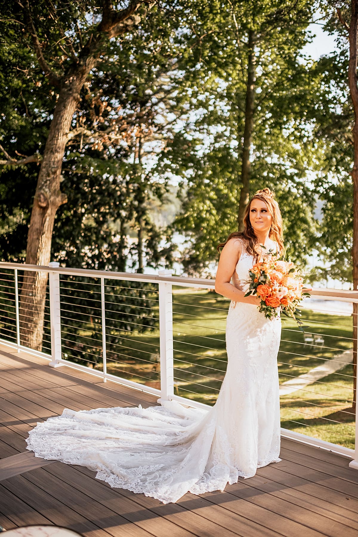 bride on balcony of lake house 
