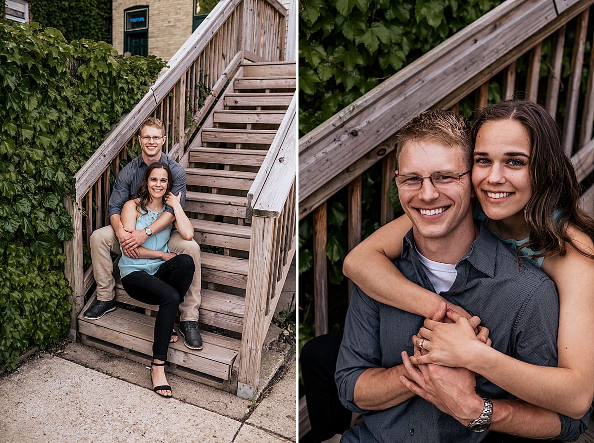 engaged couple sitting on wood stairs together downtown burlington engagement session