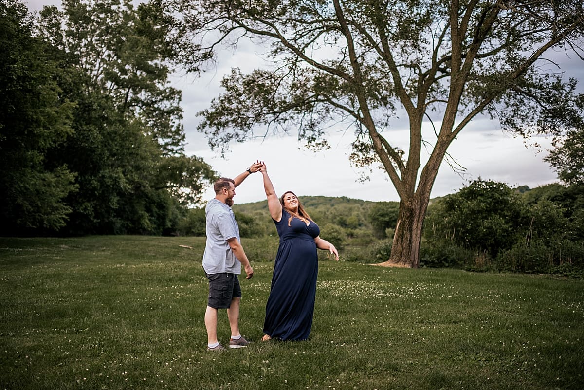 mom and dad dancing in a field