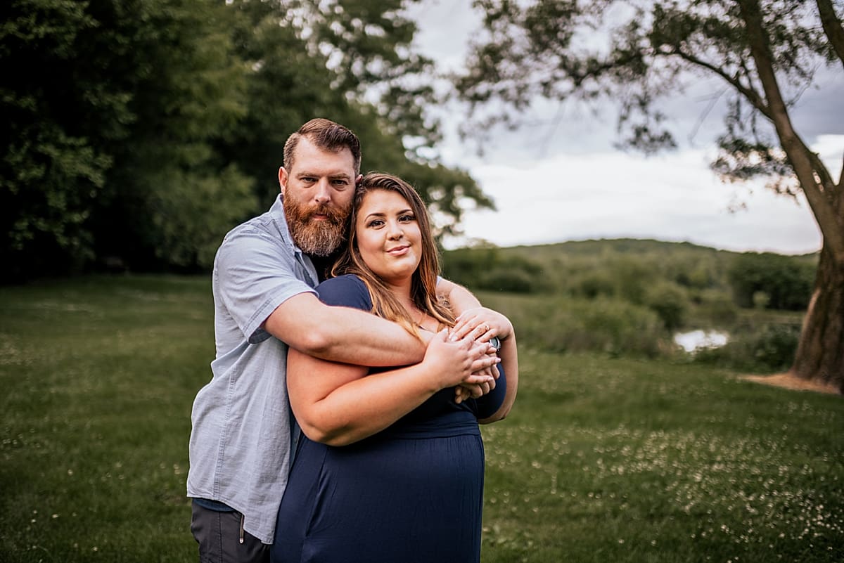 husband hugging wife from behind elkhorn couples photography