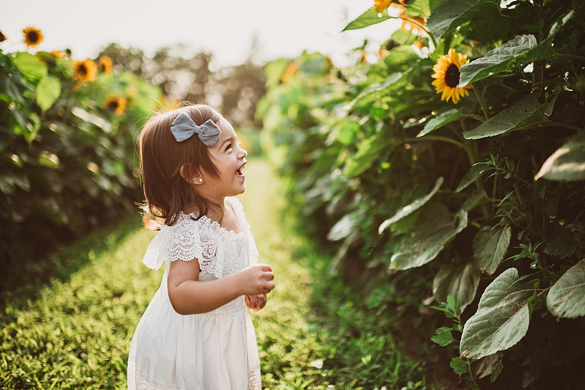 little girl excited to see sunflowers