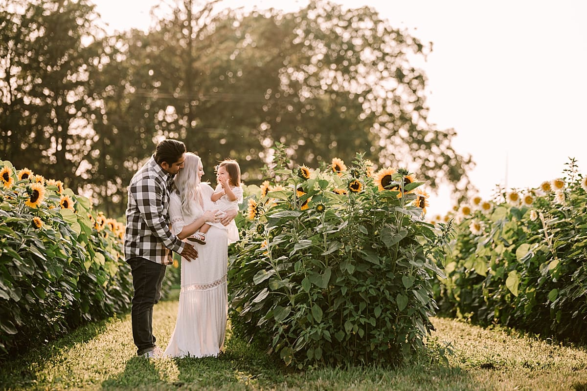 maternity photos in a summer field of sunflowers
