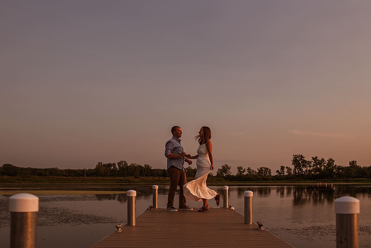 couple dancing at sunset at the end of the pier at bong recreation state park