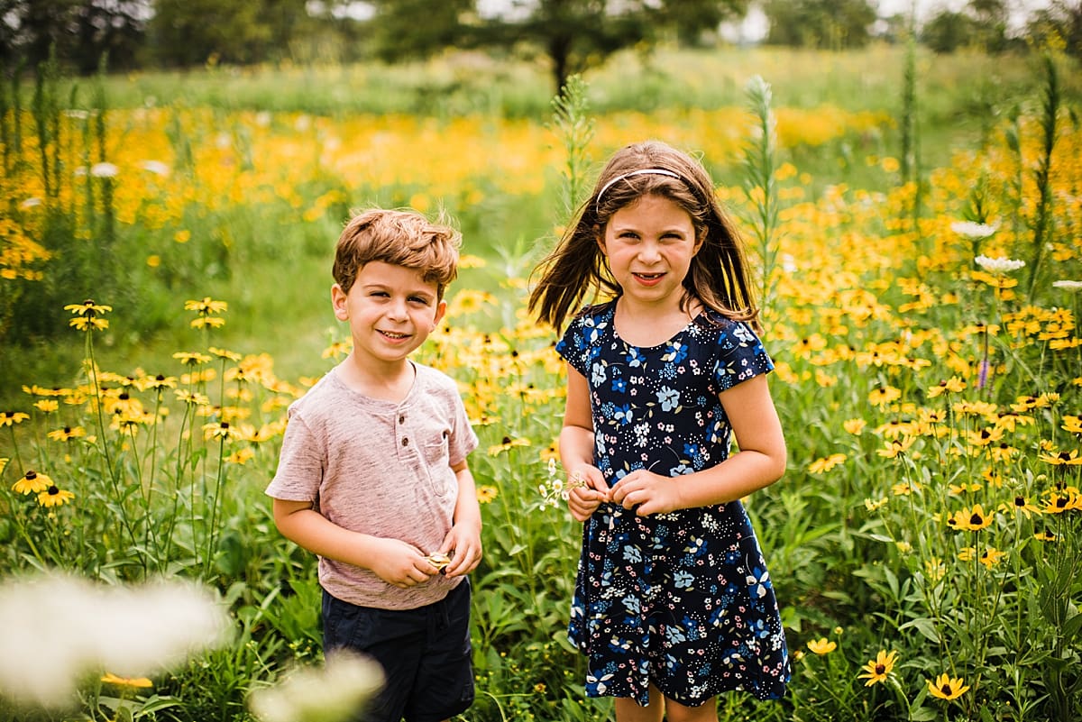 brother and sister in a field of flowers
