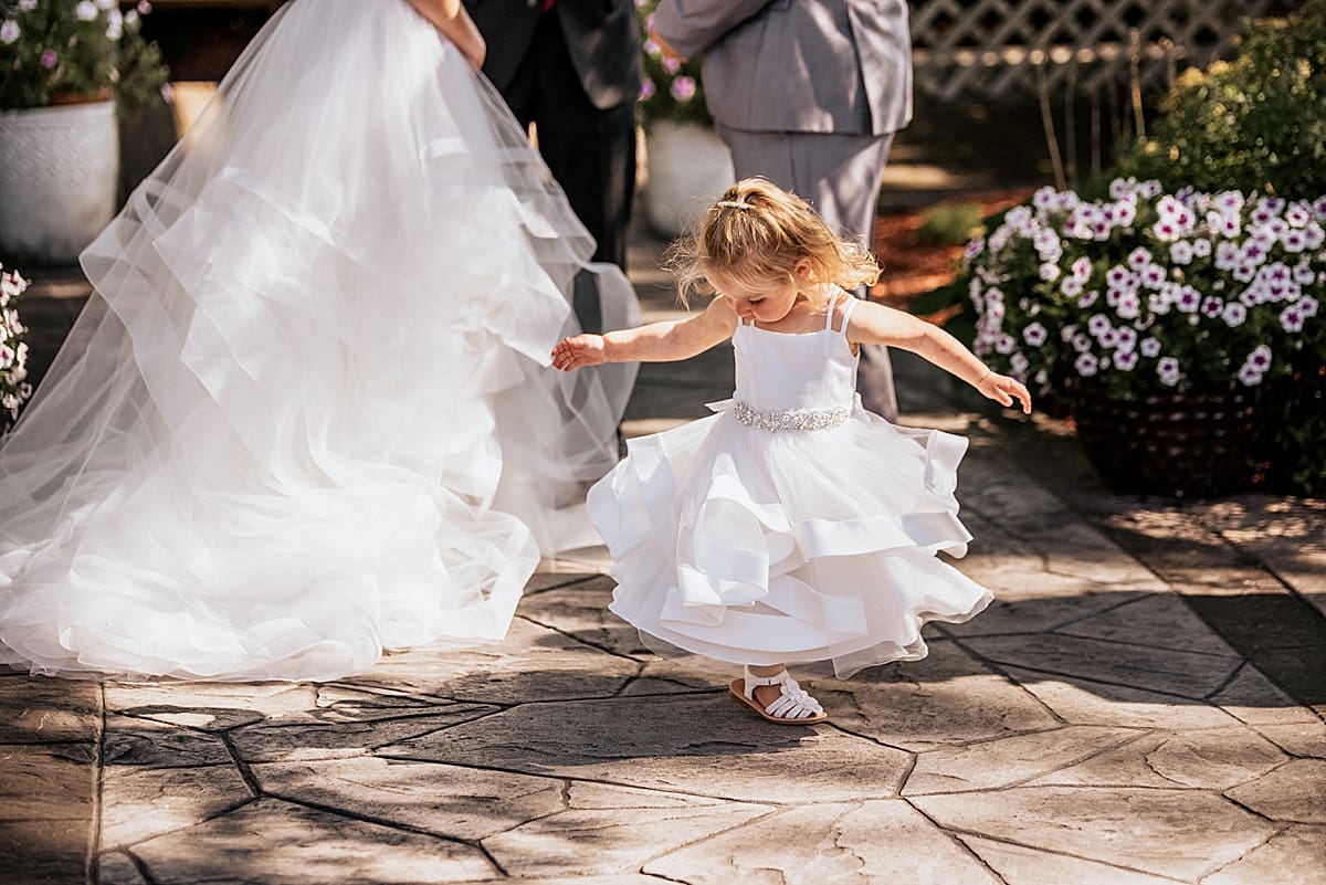 little girl twirling during wedding ceremony