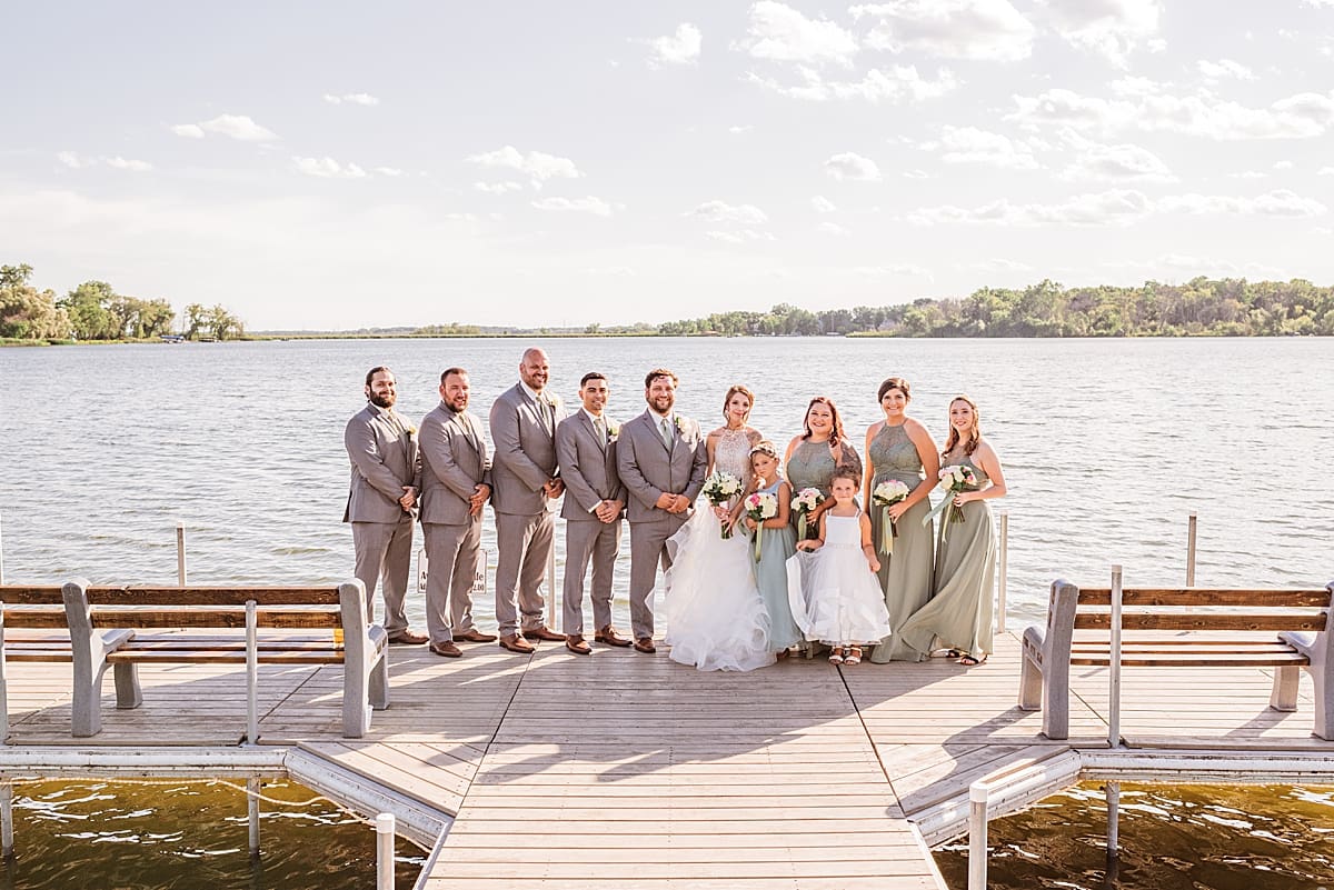 wedding party at the end of the pier for bass bay brewhouse wedding in muskego wisconsin