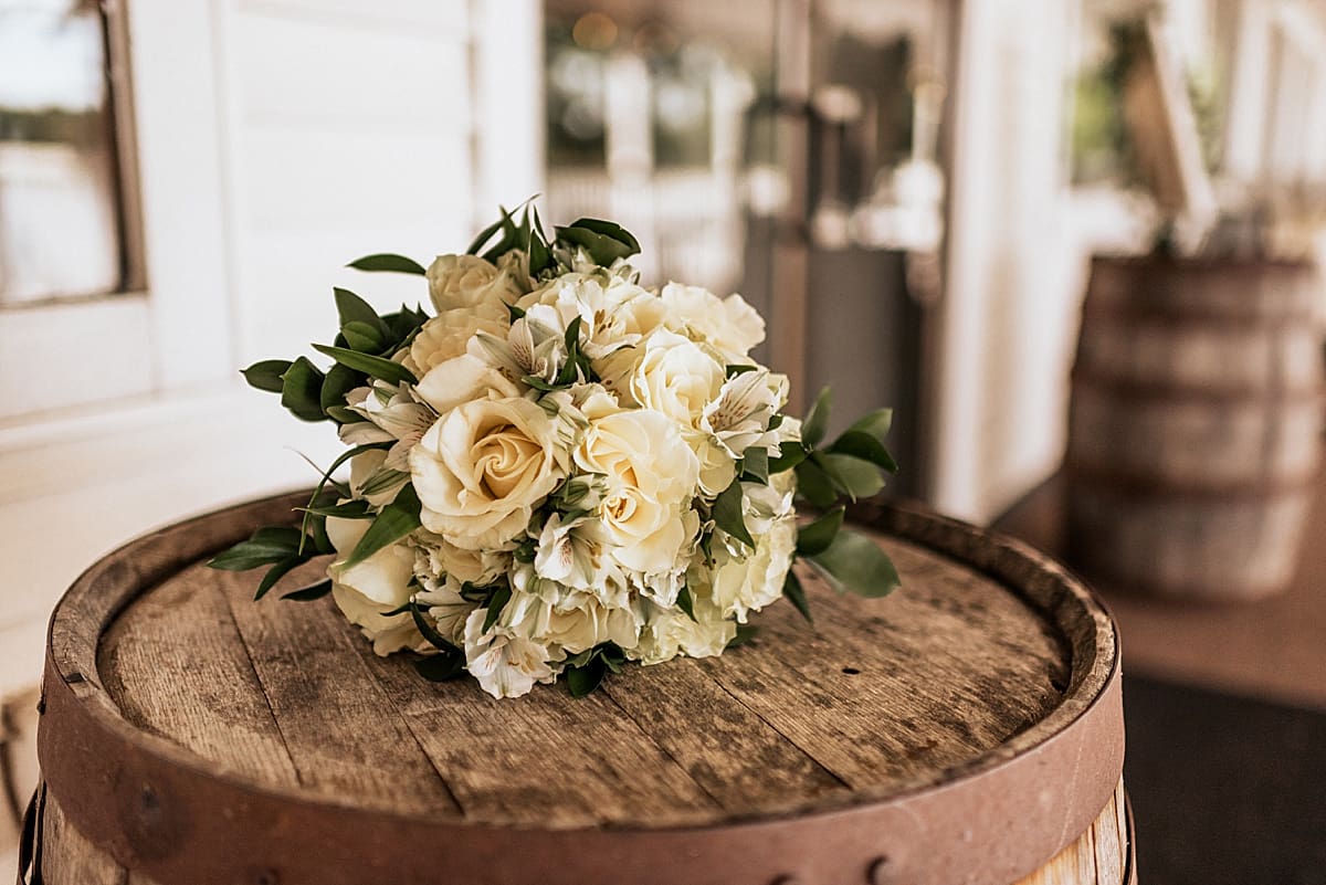 white bridal bouquet on a whiskey barrel