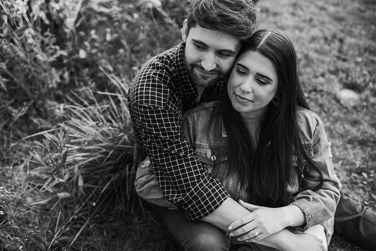 black and white photo of couple snuggling