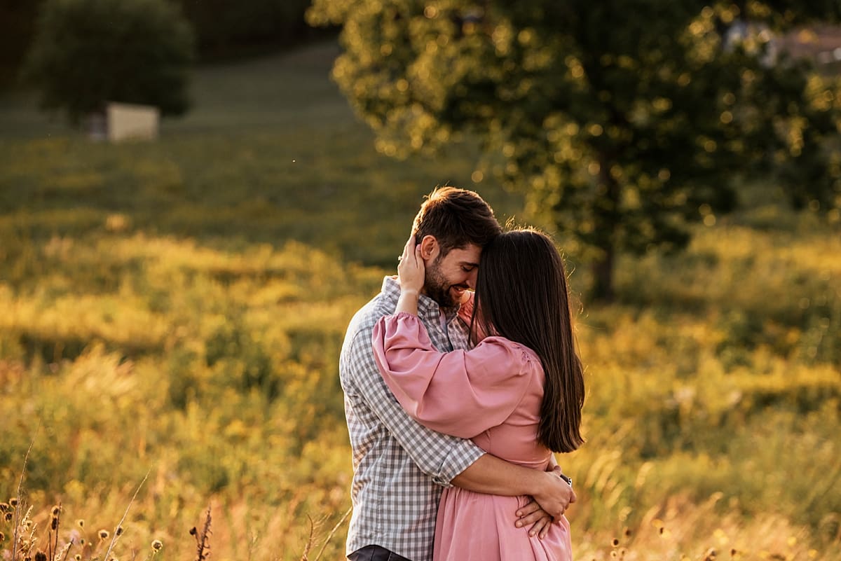 couple wrapped into each other for sunset engagement photos