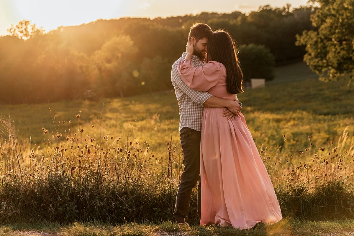 couple wrapped into each other for sunset engagement photos