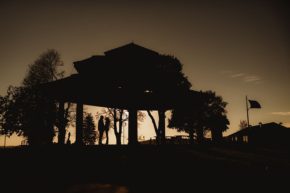 silhouette couples photos with gazebo and flag
