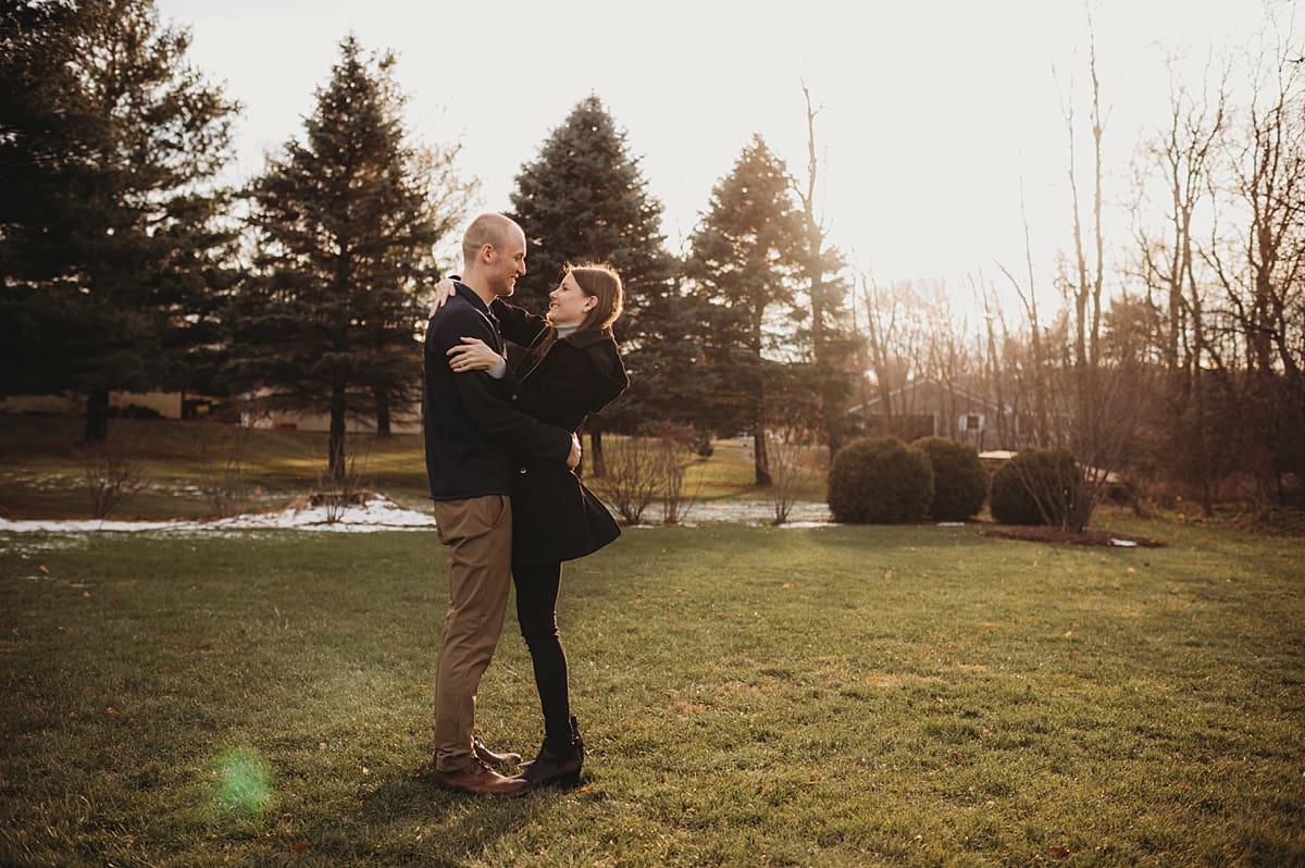 man and woman hugging and trying to stay warm during engagement session
