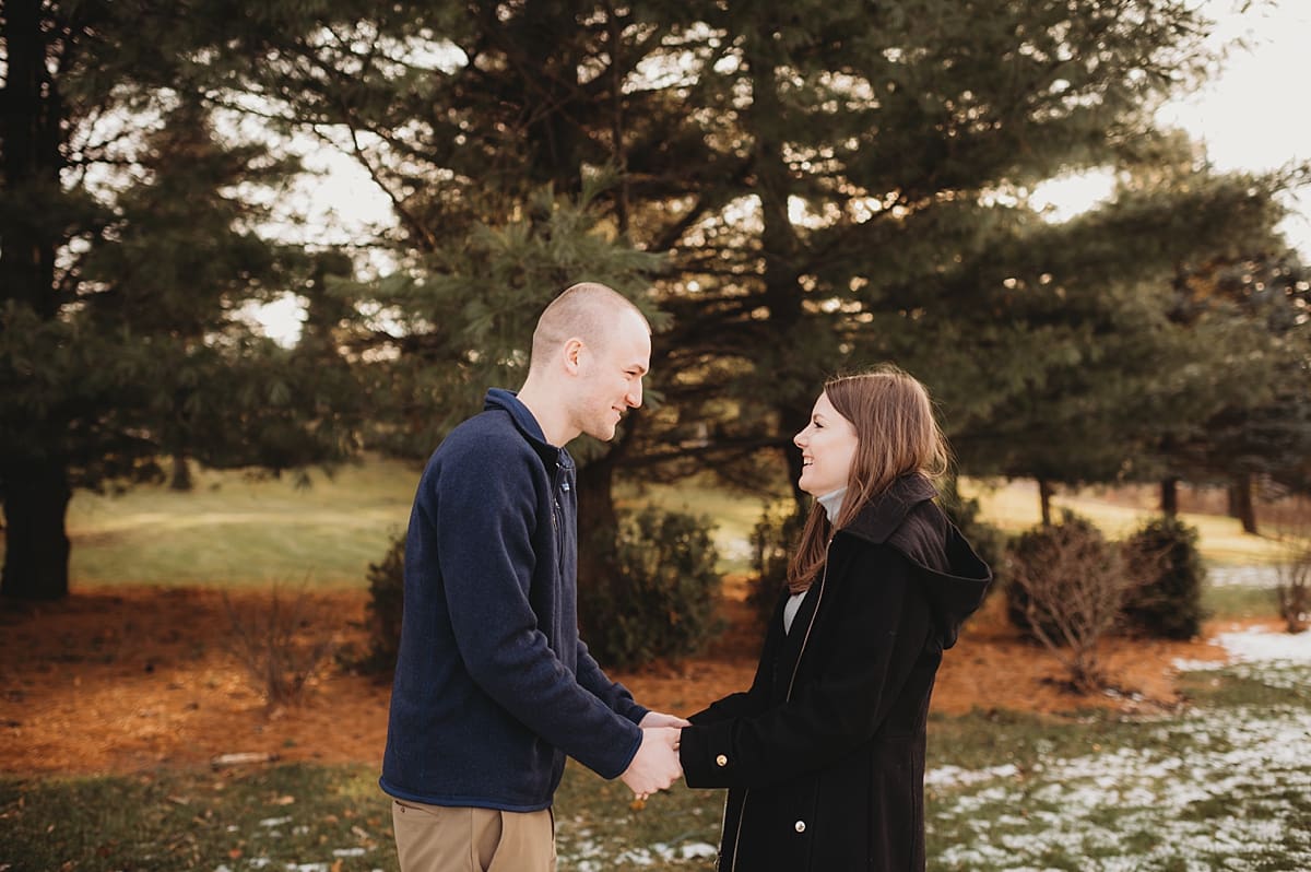 couple holding hands and talking during engagement session