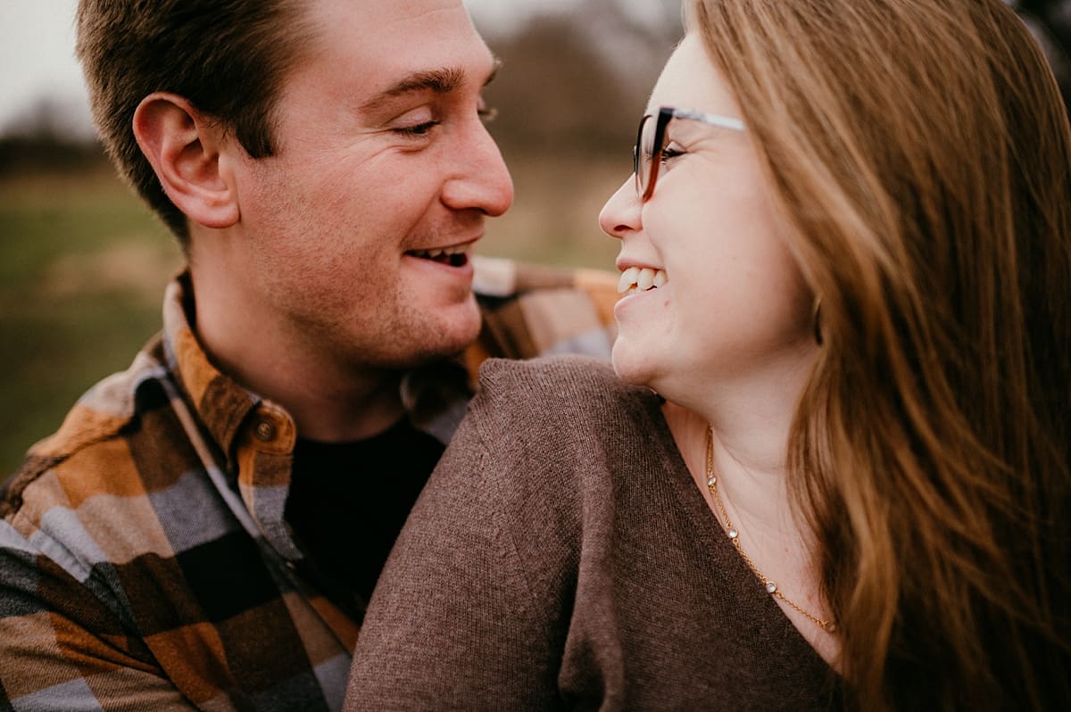 couple laughing together at engagement session